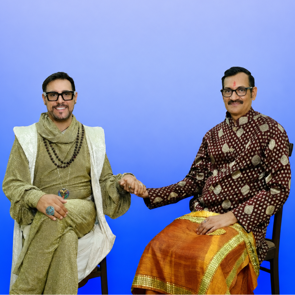 Portrait of Prince Manvendra Singh Gohil and Prince DeAndre, Duke of Hanumanteshwar, seated together and holding hands, featured on the H1927LLC website for their memoir A Royal Commitment: Ten Years of Marriage and Activism.